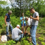 Collecting water monitoring data with data loggers. Photo by Evergreen Conservancy