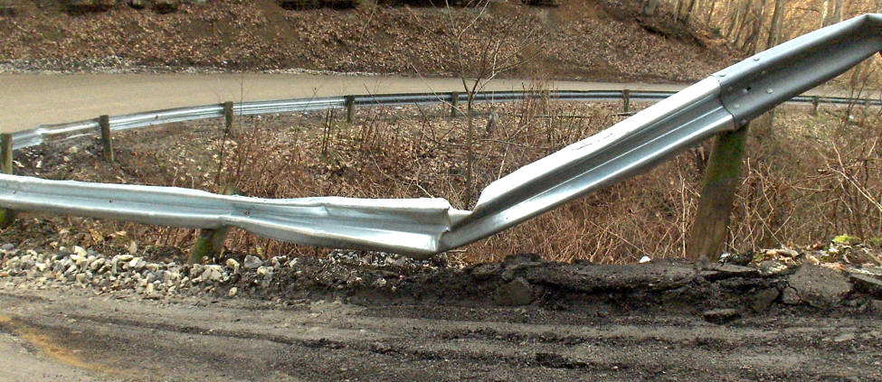 Figure 1. Switchback curve on Barker Run Road has seen its share of damage from the increase in truck traffic.