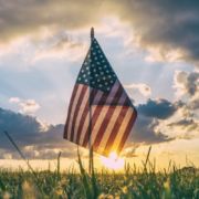American flag, sunset - Photo by Aaron Burden. Vote boldly!