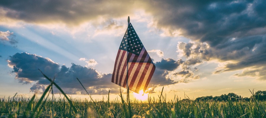 American flag, sunset - Photo by Aaron Burden. Vote boldly!
