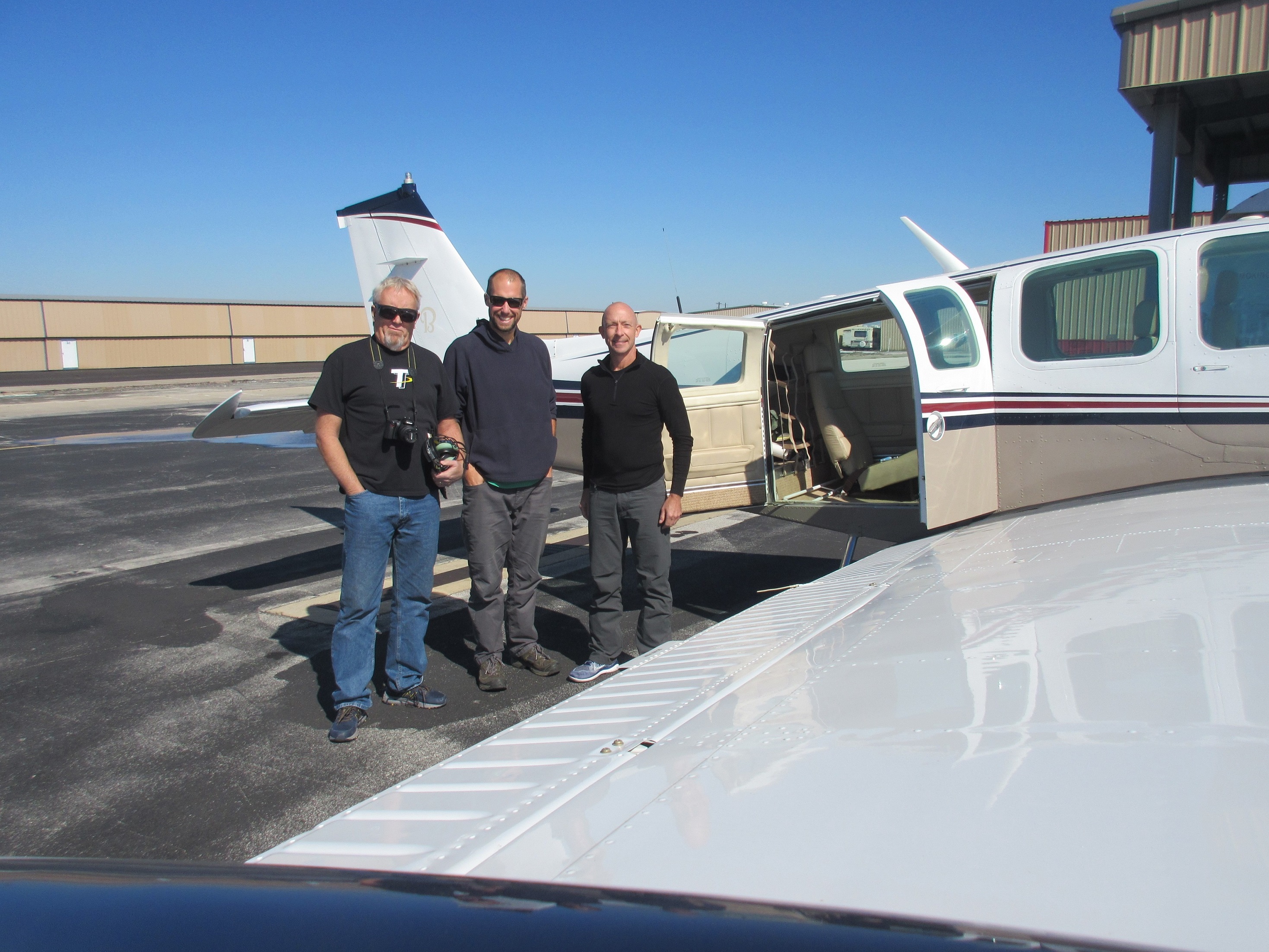 Group shot in front of airplane