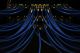 Close-up of blue Ethernet cables plugged into a network switch, with indicator lights glowing, inside a data center server rack.